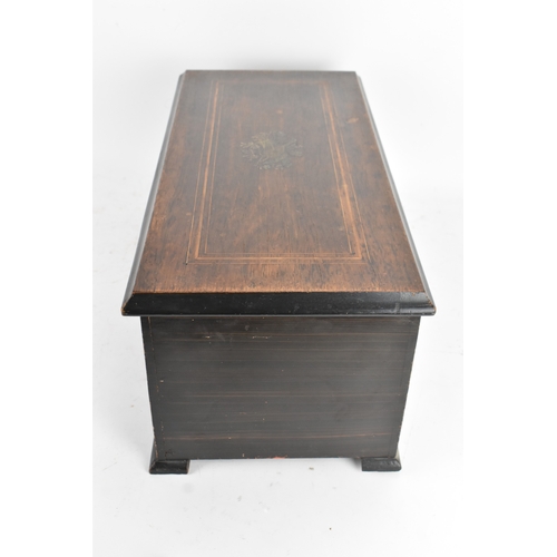 224 - A Victorian ebonized cylinder music box, the rectangular case with line inlay and central motif, enc... 