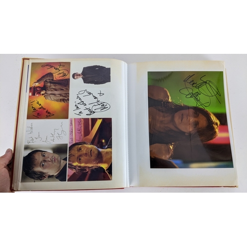 90 - A Doctor Who album of autographs on photos, signed by several cast members to include Tom Baker, Kar... 