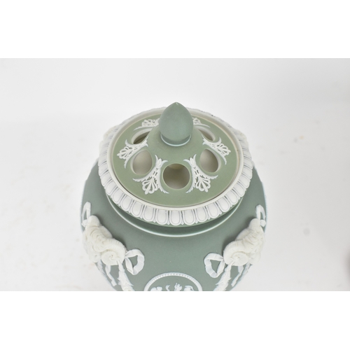 99 - A Wedgwood green jasperware covered pot pourri urn, of ovoid form with domed pierced cover and inner... 