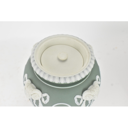 99 - A Wedgwood green jasperware covered pot pourri urn, of ovoid form with domed pierced cover and inner... 