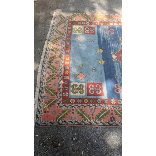 A Turkish rug with geometric motifs in pastel colours, 332cm w x 228cm ...