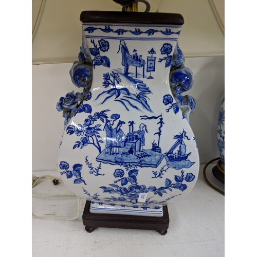 2 - Three modern table lamps decorated in blue and white, two raised on circular plinths and one on a sq... 