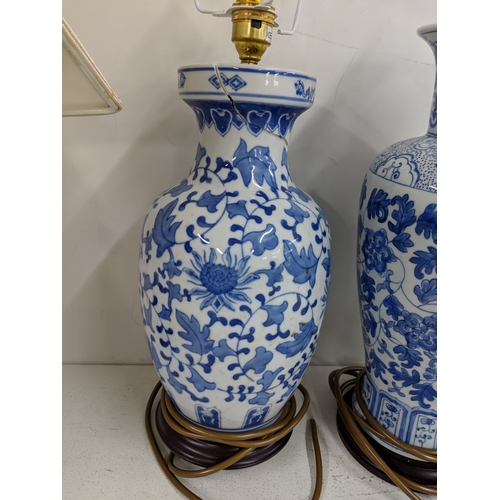 2 - Three modern table lamps decorated in blue and white, two raised on circular plinths and one on a sq... 
