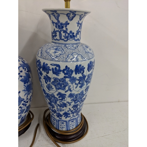 2 - Three modern table lamps decorated in blue and white, two raised on circular plinths and one on a sq... 