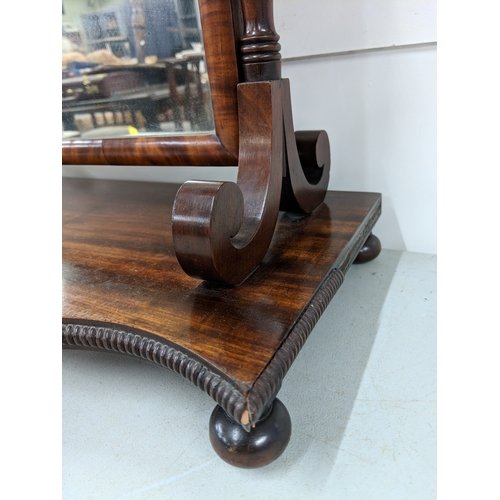 41 - A late Victorian mahogany dressing table mirror with turned finials and supports on a base with a ri... 