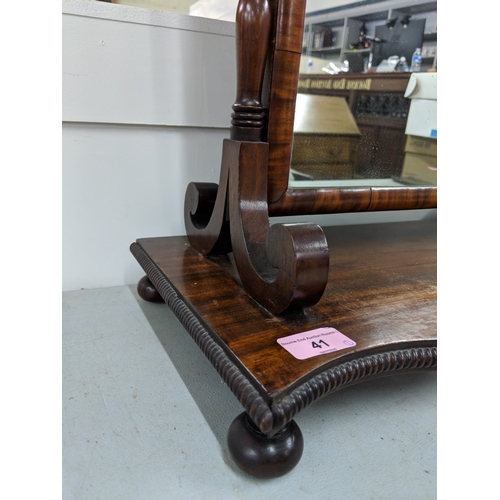 41 - A late Victorian mahogany dressing table mirror with turned finials and supports on a base with a ri... 