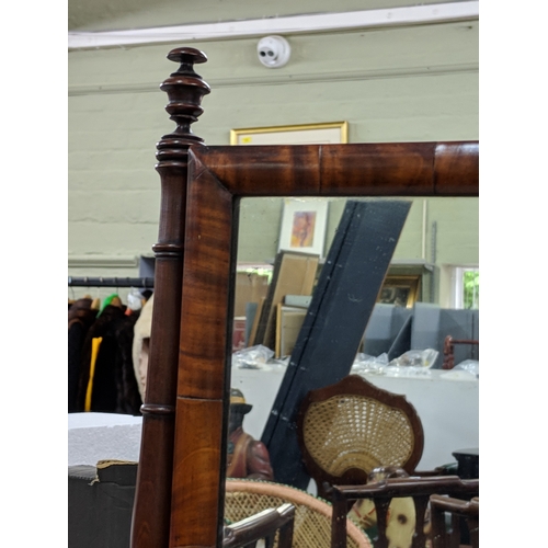 41 - A late Victorian mahogany dressing table mirror with turned finials and supports on a base with a ri... 