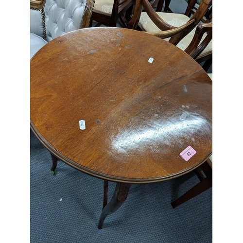 42 - An early 20th century mahogany circular table raised on cabriole legs, united with an undershelf, ra... 