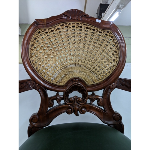 55 - A Hampton French rattan chair with a rattan back with intricate detail on the back and arms with stu... 