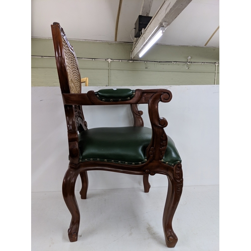 55 - A Hampton French rattan chair with a rattan back with intricate detail on the back and arms with stu... 