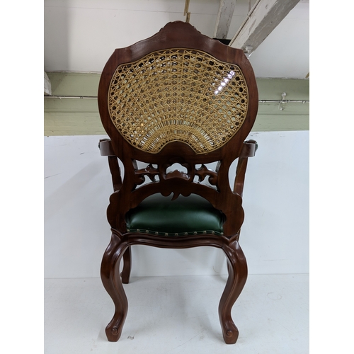 55 - A Hampton French rattan chair with a rattan back with intricate detail on the back and arms with stu... 