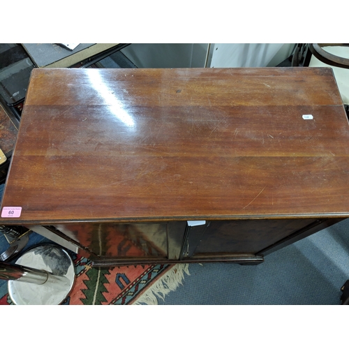 60 - A late 19th/early 20th century flame mahogany cupboards with a pair of panelled doors revealing a sh... 