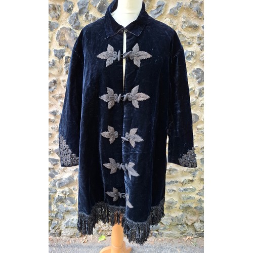 A 19th Century Sharman & Son 'Silk Merciers to The Queen, Leigton Buzzard' navy velvet lounge jacket having a black tassel fringe to the hem and embroidered cuffs with embroidered leaf design to the front double toggle fastening (one missing) and a padded lining with single pocket approx 44" chest x 39" long. Location:Rail