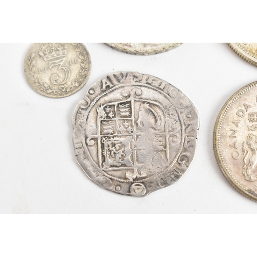 25 - A group of six coins to include a Charles I (1625–1649) hammered silver shilling, having triangle in... 