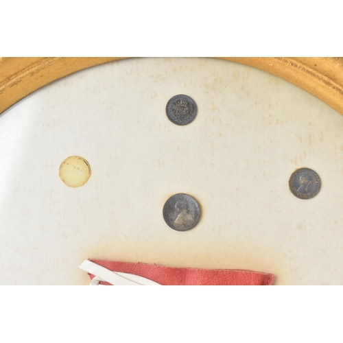 12 - The Royal Maundy 1959 - A framed set of 14 coins and red purse issued at the Royal Maundy service at... 