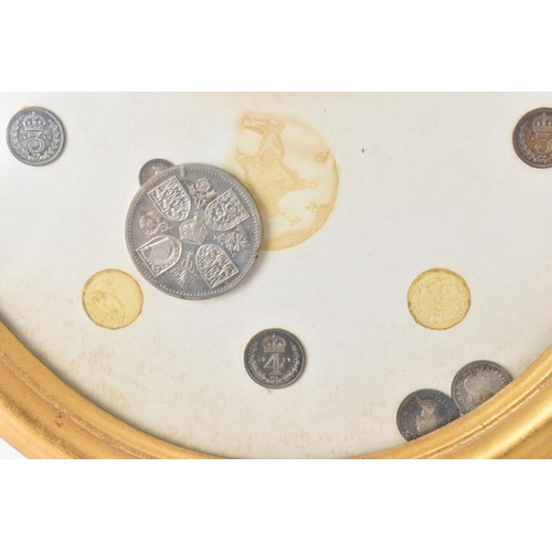 12 - The Royal Maundy 1959 - A framed set of 14 coins and red purse issued at the Royal Maundy service at... 