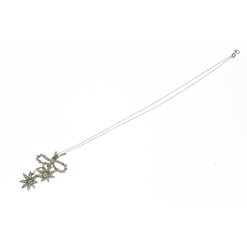 14 - A diamond white metal floral spray pendant on 9ct gold chain, the brooch-pendant modelled as a ribbo... 
