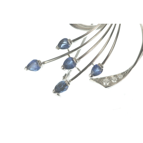 15 - A sapphire and diamond 18ct white gold brooch, of floral spray design set with pear-cut sapphires to... 