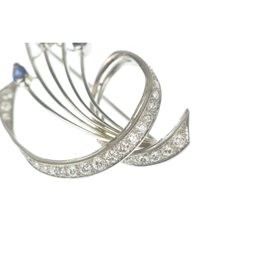15 - A sapphire and diamond 18ct white gold brooch, of floral spray design set with pear-cut sapphires to... 