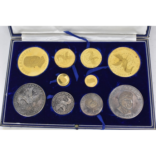 16 - A cased commemorative set of John F Kennedy medallions by Gregory and Co. Ltd, comprising six gold m... 