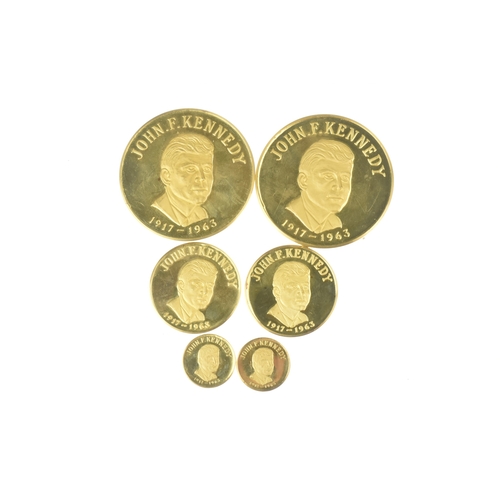 16 - A cased commemorative set of John F Kennedy medallions by Gregory and Co. Ltd, comprising six gold m... 