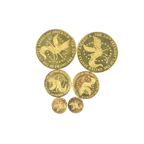 16 - A cased commemorative set of John F Kennedy medallions by Gregory and Co. Ltd, comprising six gold m... 