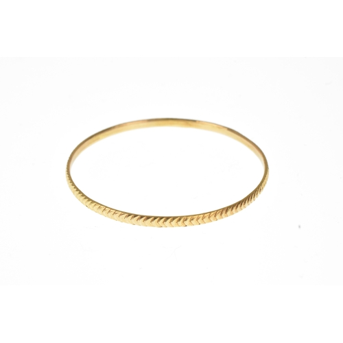 19 - A yellow gold bangle, with chevron design pattern, unmarked, 45mm outer diameter, 4.7 grams
If there... 