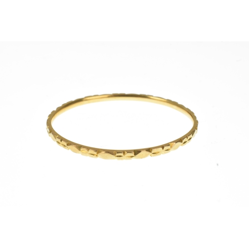 20 - A yellow gold bangle, with repeating diamond-shaped motifs, outer diameter 47mm x 43mm, 8.5 grams
If... 