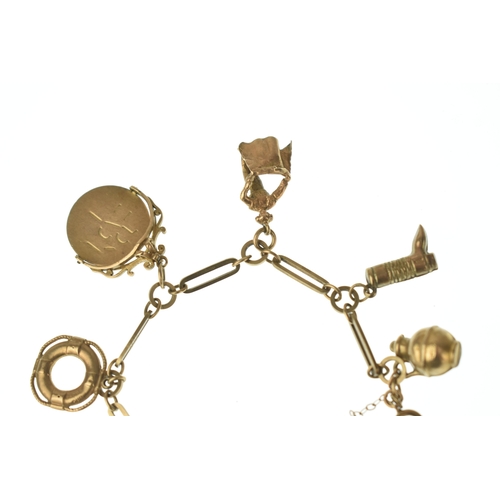 22 - A 9ct gold charm bracelet,  fitted with an assortment of charms including a key, boot, ballet dancer... 