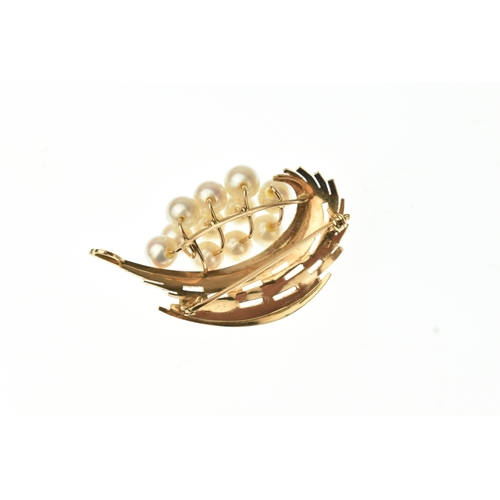 23 - A cultured pearl set 14ct gold spray brooch, designed as a stylised abstract foliate spray with text... 