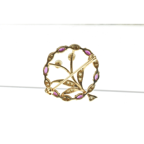 25 - An Edwardian seed pearl, ruby and pearl  9ct gold floral brooch, designed as a circular foliate spra... 