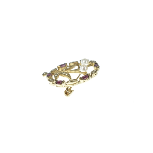 25 - An Edwardian seed pearl, ruby and pearl  9ct gold floral brooch, designed as a circular foliate spra... 