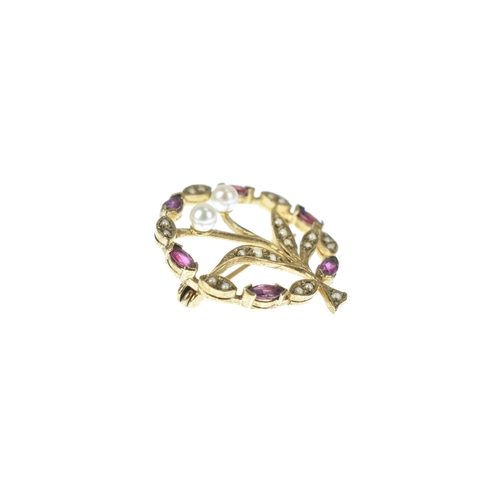 25 - An Edwardian seed pearl, ruby and pearl  9ct gold floral brooch, designed as a circular foliate spra... 