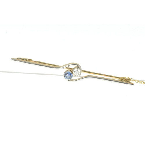 27 - An early 20th century two-stone diamond and sapphire bar brooch, of crossover design, set with an ol... 