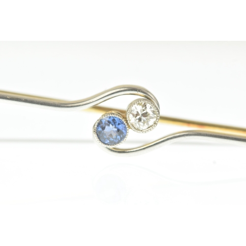 27 - An early 20th century two-stone diamond and sapphire bar brooch, of crossover design, set with an ol... 