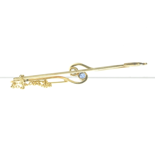 27 - An early 20th century two-stone diamond and sapphire bar brooch, of crossover design, set with an ol... 