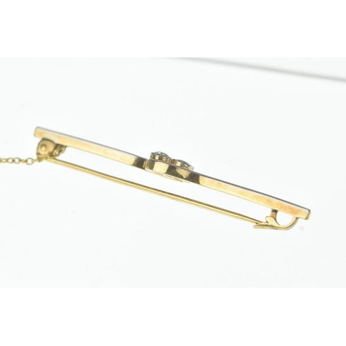 27 - An early 20th century two-stone diamond and sapphire bar brooch, of crossover design, set with an ol... 