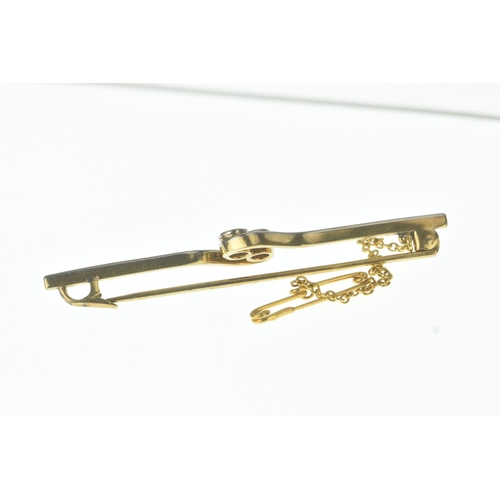 27 - An early 20th century two-stone diamond and sapphire bar brooch, of crossover design, set with an ol... 