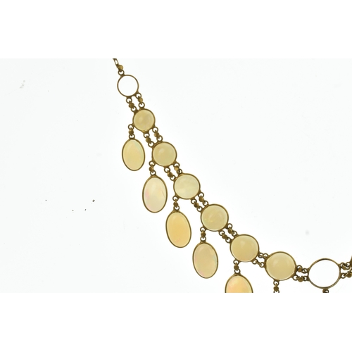 28 - An opal 9ct gold opal necklace, set with twenty-six graduated oval cabochon opals  individually beze... 