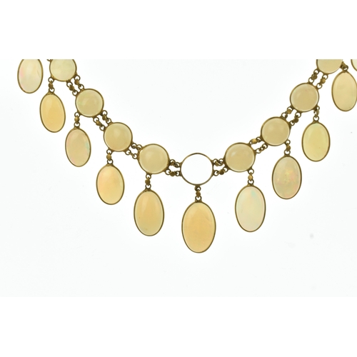 28 - An opal 9ct gold opal necklace, set with twenty-six graduated oval cabochon opals  individually beze... 