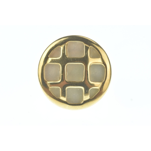 29 - A modern 18ct gold and mother-of-pearl ring, in the Cartier design, the domed oval mother-of-pearl p... 