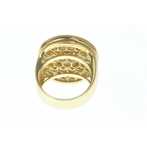 29 - A modern 18ct gold and mother-of-pearl ring, in the Cartier design, the domed oval mother-of-pearl p... 