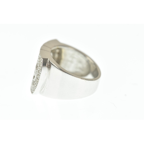 30 - A diamond 18ct white gold ring, in the Bulgari design, the wide rectangular face pavé-set with brill... 