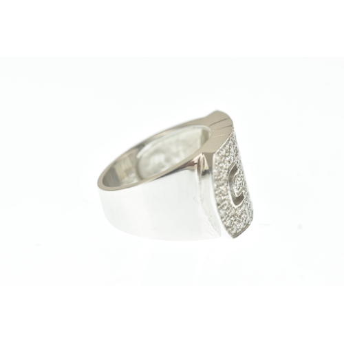 30 - A diamond 18ct white gold ring, in the Bulgari design, the wide rectangular face pavé-set with brill... 