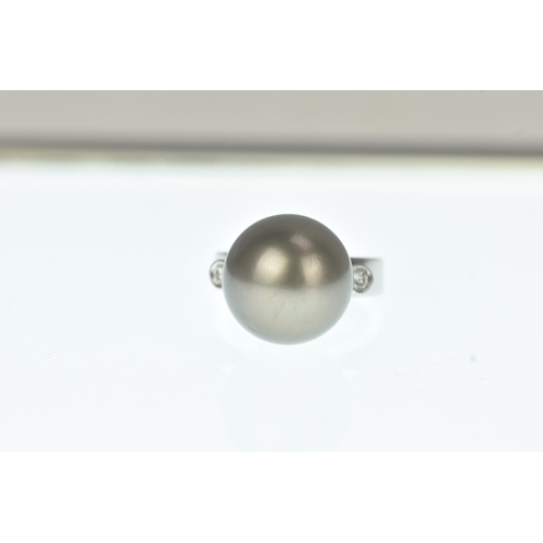 33 - A pearl and diamond 18ct white gold dress ring, claw-set with a large black cultured pearl measuring... 