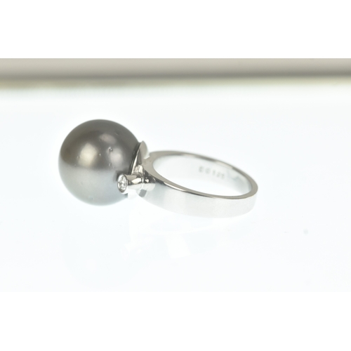33 - A pearl and diamond 18ct white gold dress ring, claw-set with a large black cultured pearl measuring... 