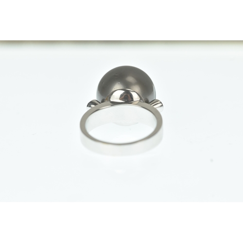 33 - A pearl and diamond 18ct white gold dress ring, claw-set with a large black cultured pearl measuring... 