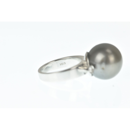 33 - A pearl and diamond 18ct white gold dress ring, claw-set with a large black cultured pearl measuring... 