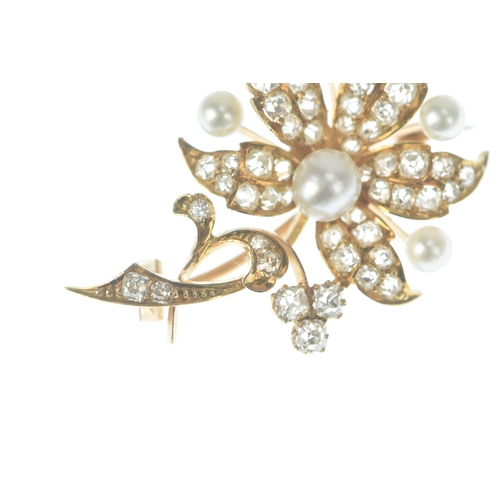 46 - A diamond and pearl 14ct gold floral brooch designed as a scrolling foliate spray set throughout wit... 