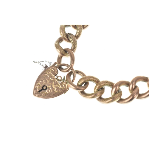 47 - A 9ct gold curb link bracelet, having alternating textured and plain links, fitted with an engraved ... 